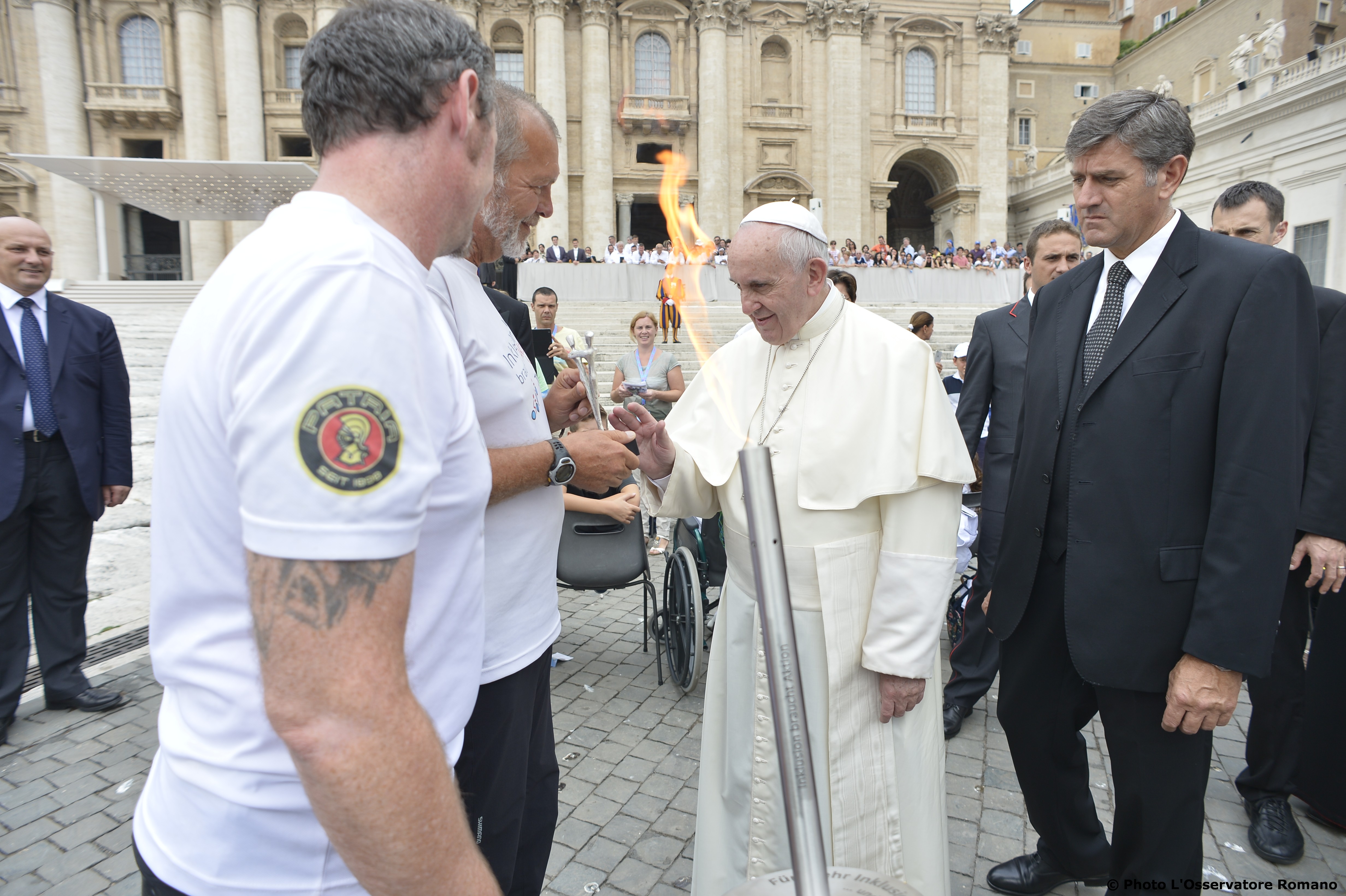 Pope Francis blesses the torch of two Paralympic athletes after the General Audience of Wednesday