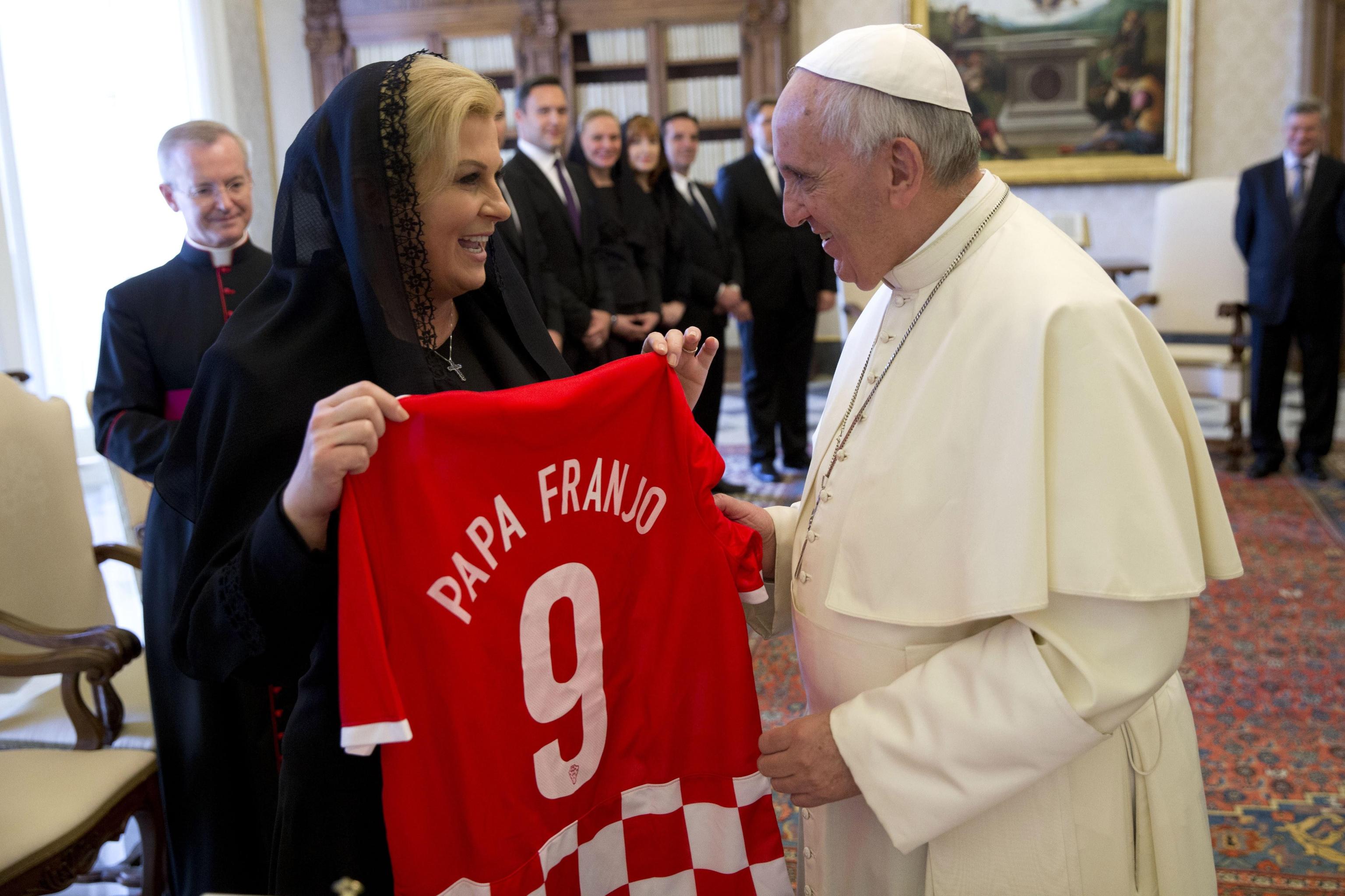 Pope Francis receives a national soccer team jersey bearing his name from Croatia's President Kolinda Grabar Kitarovic