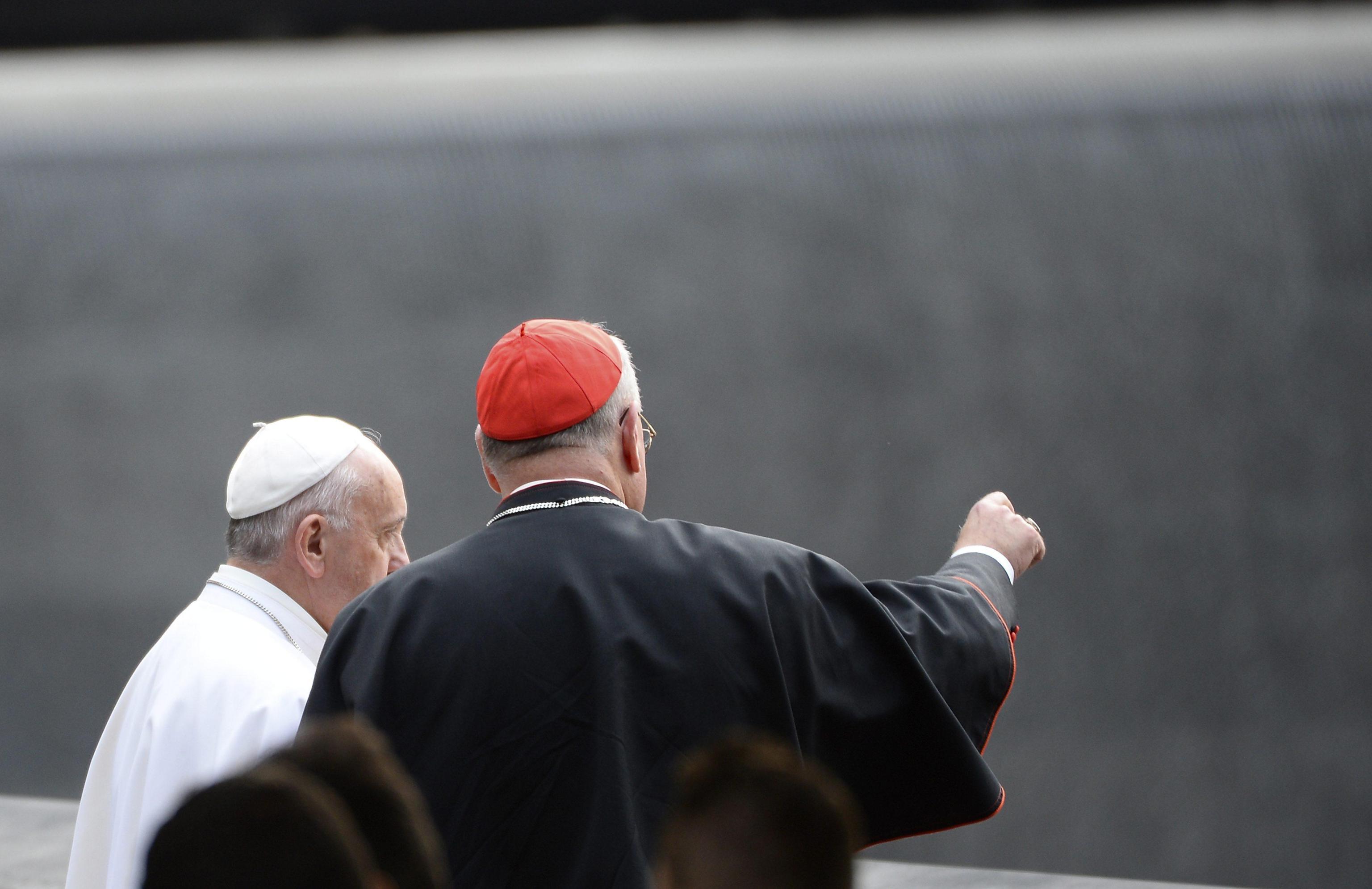 Pope Francis listens as Cardinal Dolan points out features of the the 9/11 Memorial