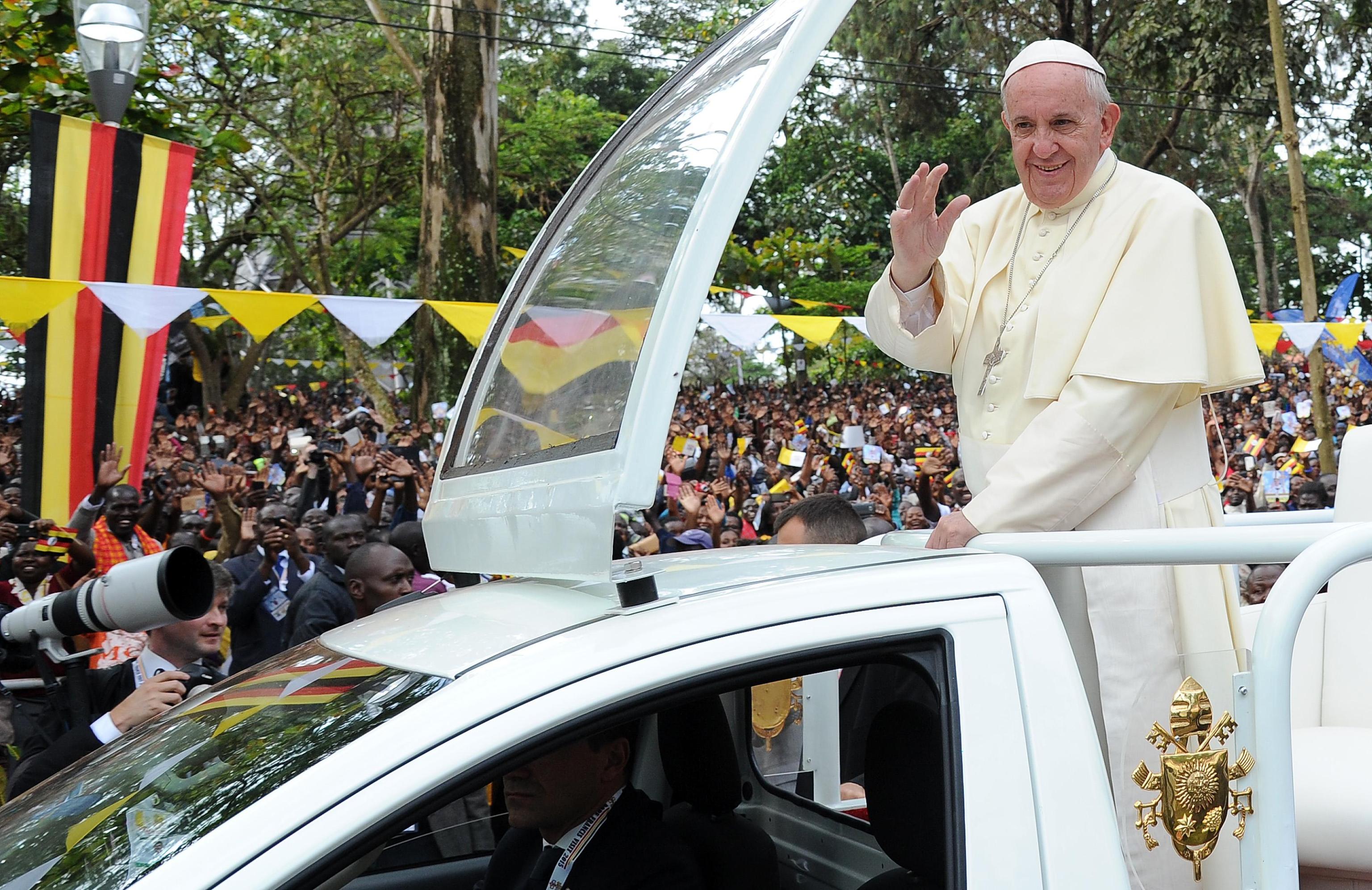 Pope Francis waves from the popemobile to the crowd of faithfull at his arrival at a Mass for the martyrs of Uganda celebrated by near the Catholic shrine of Namugongo in Kampala