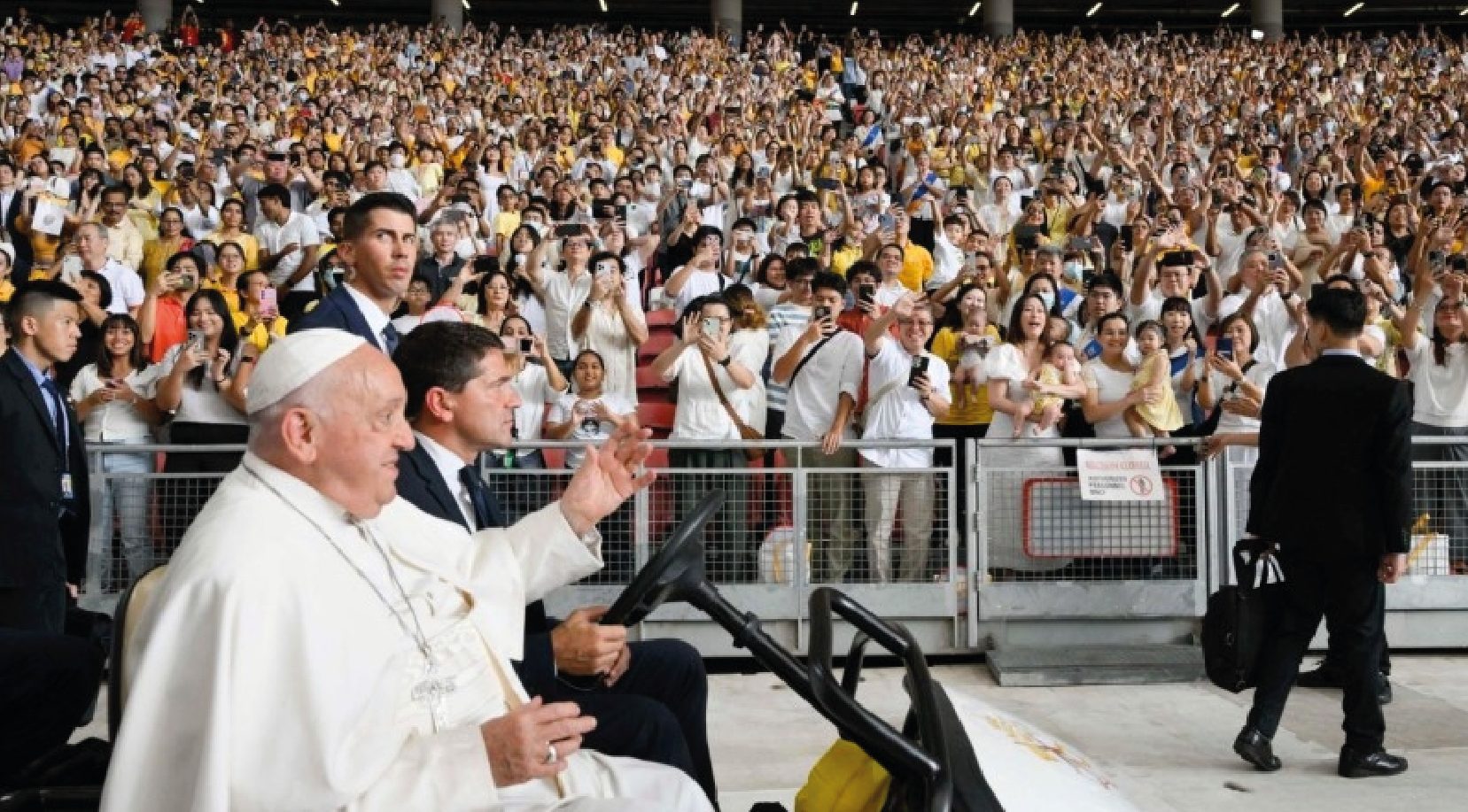 where he climbed into a golf cart to greet the 50,000 faithful who had come to witness the occasion