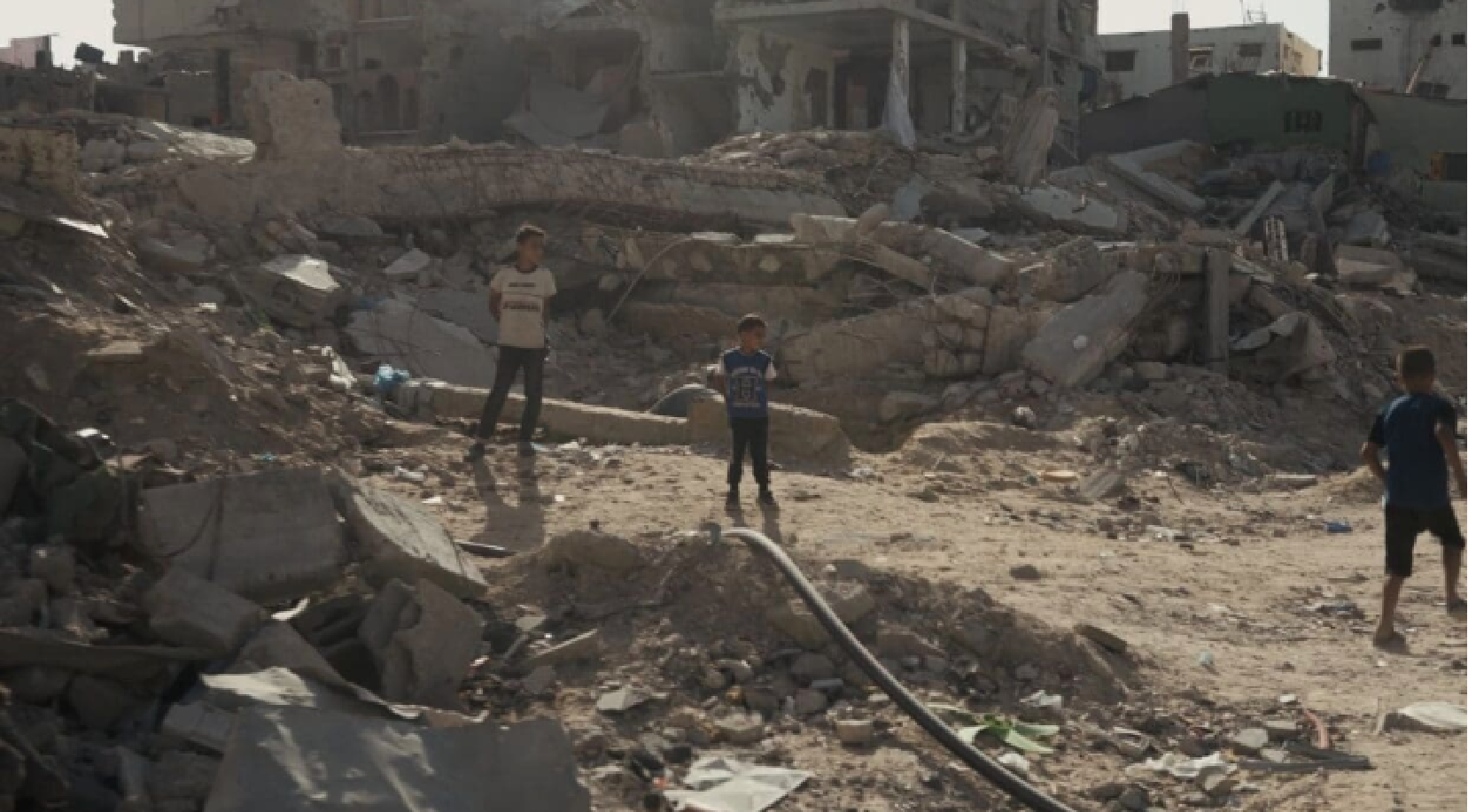 children play amid destruction in Gaza